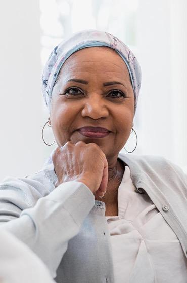 A Black elder engaged in a community health conversation